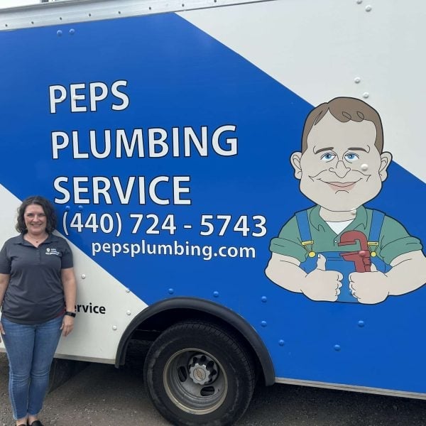 Peps Plumbing Service customer service rep beside the box truck